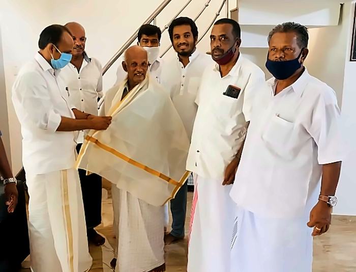 Mr. T.A. Pathrose Tholanikunnel being honoured with a shawl