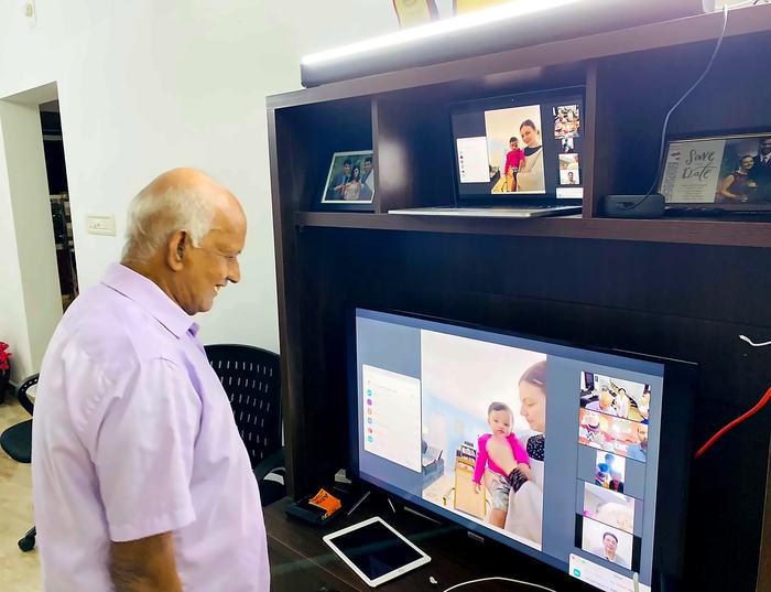Mr. T.A. Pathrose Tholanikunnel on a video call with his grandchildren